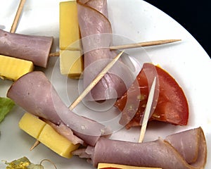 Food Platter. Ham and cheese serving on a white plate. Very closeup
