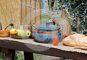 Food Pots and Bottles on a Wooden Table at a Historical Medieval Reenactment