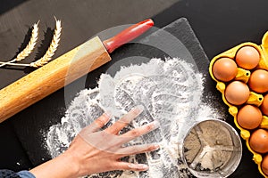 Food preparation concept over head shot Kneading dough for bakery, pizza or pasta on black background with copy space