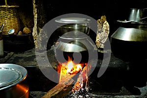 Food is prepared in an old village kitchen with firewood  in Kerala