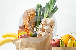 Food products from the grocery shop. Food shopping and delivery concept. Bread, eggs, bananas, fruits and vegetables in the brown