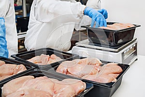 Food products meat chicken in plastic packaging on the conveyor.Chicken fillet production line . Meat processing equipment. Line