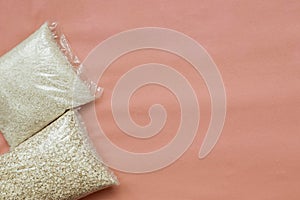 Food products rice and oatmeal lie on pink background. Useful complex carbohydrates, proper nutrition. Crisis food supply for the