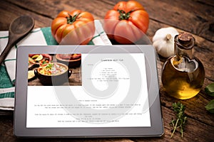 Food recipes tablet computer on rustic wooden table