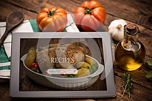 Food recipes tablet computer on rustic wooden table