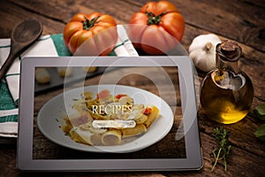 Food recipes tablet computer on rustic wooden table