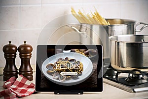 Food recipes tablet computer on rustic wooden table