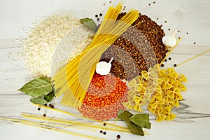 food: rice, buckwheat, spaghetti, pasta, lentils and garlic with peper on the table