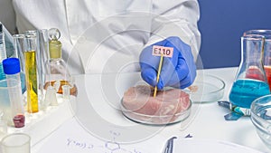 Food safety expert checking red meat in the laboratory. Labels with E additives