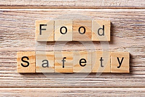 Food safety word written on wood block. Food safety text on table, concept