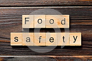 Food safety word written on wood block. food safety text on table, concept