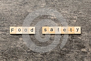 food safety word written on wood block. food safety text on table, concept