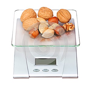 Food scale with nuts isolated on white