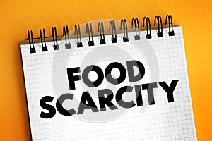 Food scarcity - lack of consistent access to enough food for every person in a household, text concept on notepad