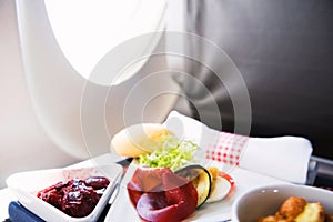 Food served on board of business class airplane on the table