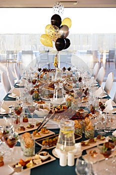 Food served on table in a white hall during a Birthday party in Eastern European Baltic Riga Latvia - Blue and teal