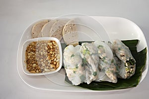 Food set of breakfast kow griep pag mor or thai steamed rice-skin dumplings pork parcels with pork sausage and sweet sauce