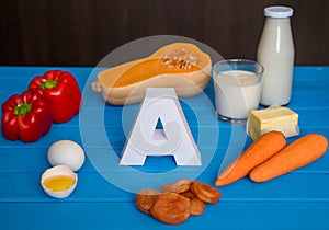 Food sources of natural vitamin A and letter A. Front view. Healthy diet concept