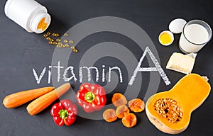 Food sources of natural vitamin A and yellow pills. Top view. Healthy diet concept