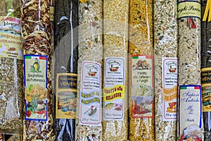 Food souvenir selection of prepackaged bags of rice for risotto with different flavors at a market in Venice, Italy