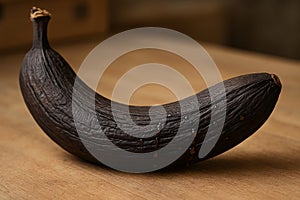 Food spoilage in banana exhibiting enzymatic browning, liquid exudate, and advanced tissue senescence due to delayed ripening photo