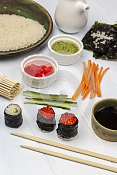 Food sticks. Sushi with caviar. Ginger and wasabi in bowls