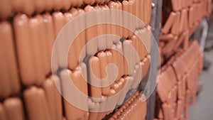 Food storage, warehouse. Meat products, sausages hanging on racks in a meat warehouse, freezer.