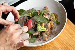 Food Stylist Garnishing a Dish