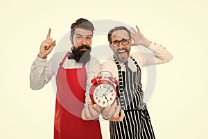 Food time. chef team in apron. Food delivery. fast food. bearded men with alarm clock. lunch time. idea. deadline. cafe