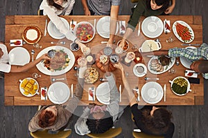 Food, top view and friends toast at a table in celebration of thanksgiving at a party or social event together. Cheers