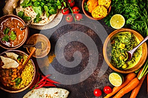 Food traditional Indian cuisine. Dal, palak paneer, curry, rice, chapati, chutney in wooden bowls on dark background