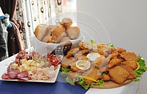 Food tray with delicious salami, pieces of sliced ham