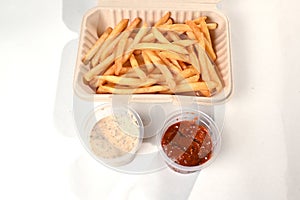 food tray french fries sausage white sausage and red sauce german food