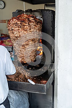 Food Trompo Pastor tacos al pastor, beef stacked in sauce with spices cooked on a taco stove, mexico