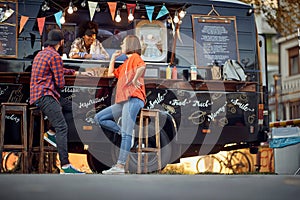 Food truck employee taking orders from customers