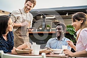 Food truck owner taking customers orders with mobile device - Happy multiracial people having a meal
