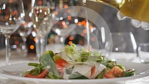 Food video footage in slow motion. Healthy food and vegetarian concept. Closeup shot of pouring olive oil over salad in