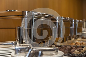 Food warmers for hot dishes on the buffet table. Catering for events. Close-up. Selective focus