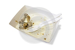 Food waste on paper plates with plastic knives and forks isolate