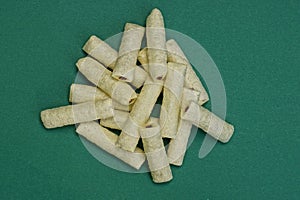 Food from white long corn sticks with chocolate filling in a heap