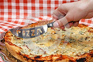 Food. Woman preparing to cut pizza