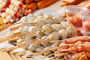 Food on wooden sticks on a counter in Thailand