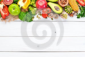 Foods containing natural fiber: avocados, kiwi, apple, tomatoes, spinach, paprika, orange, lemon. Top view.
