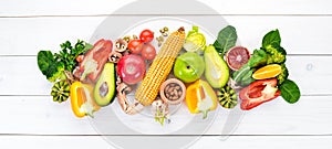 Foods containing natural fiber: avocados, kiwi, apple, tomatoes, spinach, paprika, orange, lemon. Top view.