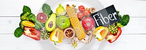 Foods containing natural fiber: avocados, kiwi, apple, tomatoes, spinach, paprika, orange, lemon. Top view.