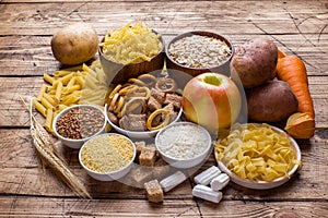 Foods high in carbohydrate on rustic wooden background