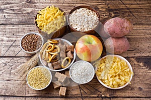 Foods high in carbohydrate on rustic wooden background