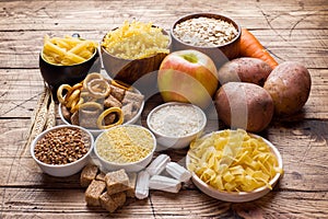 Foods high in carbohydrate on rustic wooden background photo