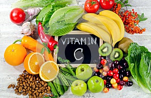 Foods High in vitamin C on white wooden board.