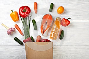 Foodstuffs useful in paper bio bag on wooden background